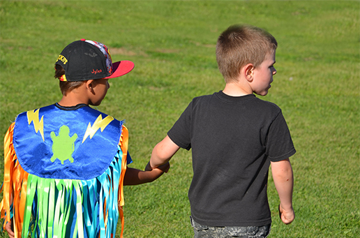 Photo of two students holding hands.