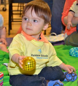 Baby toddler playing with a ball