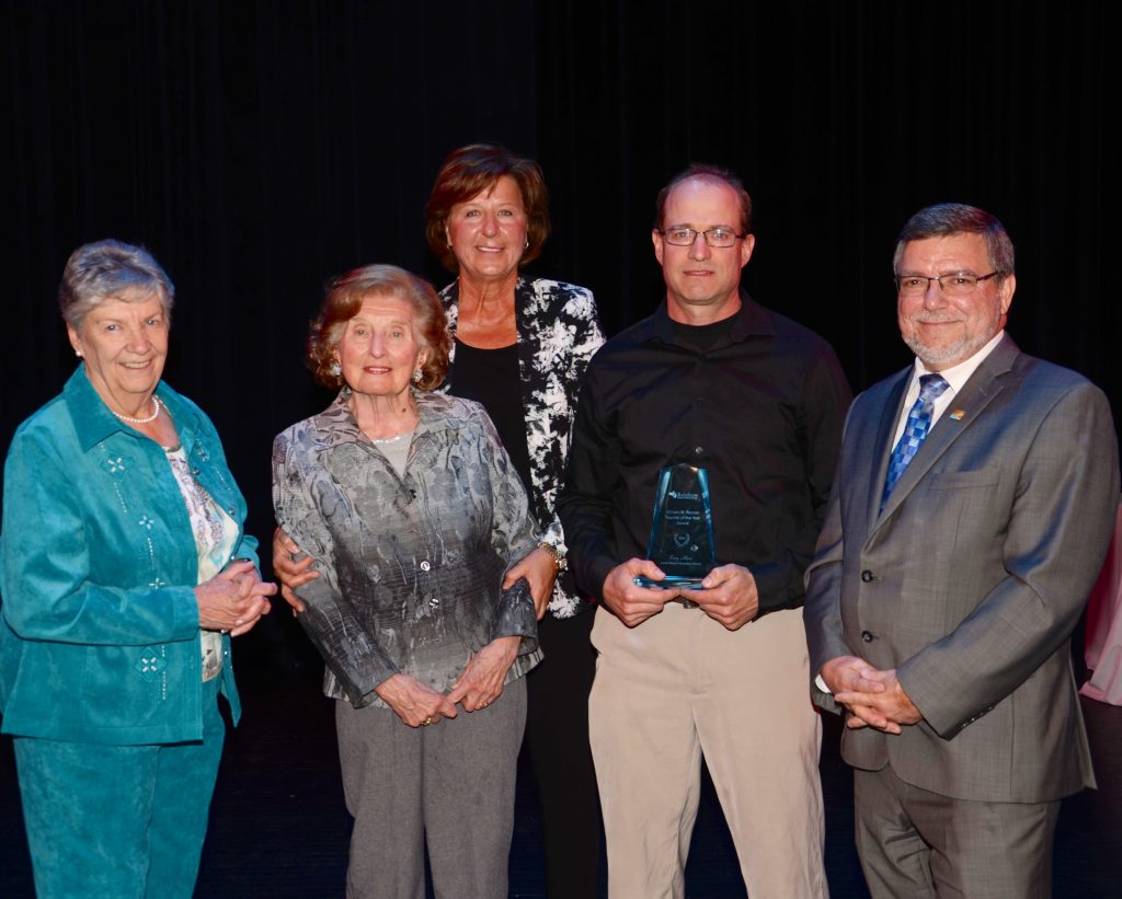 A staff member accepting an award