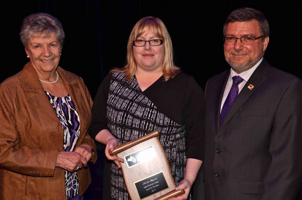 A staff member accepting an award