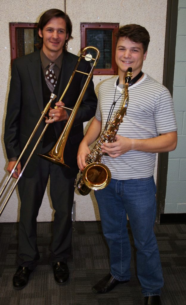 An image of a student and a teacher holding instruments