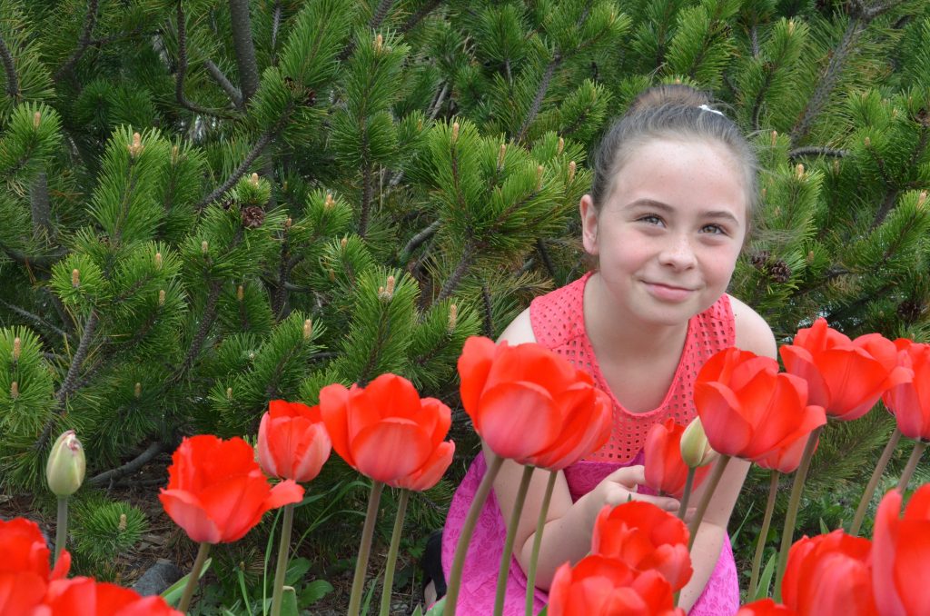 An image of a student with Tulips