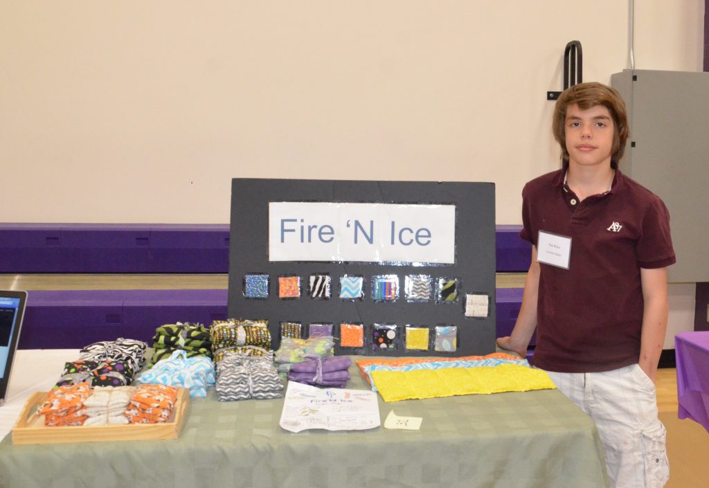 Image of a student with their entrepreneurship fair project