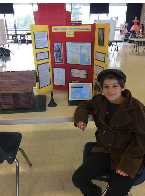Image of a student with their heritage fair project