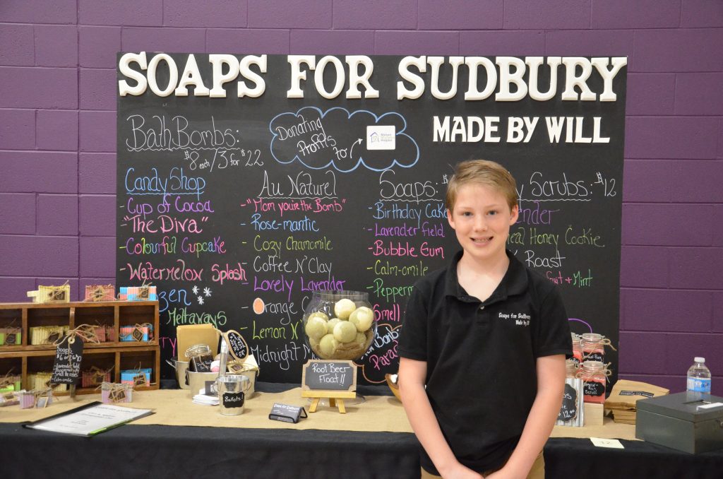 Image of a student with their entrepreneurship fair project