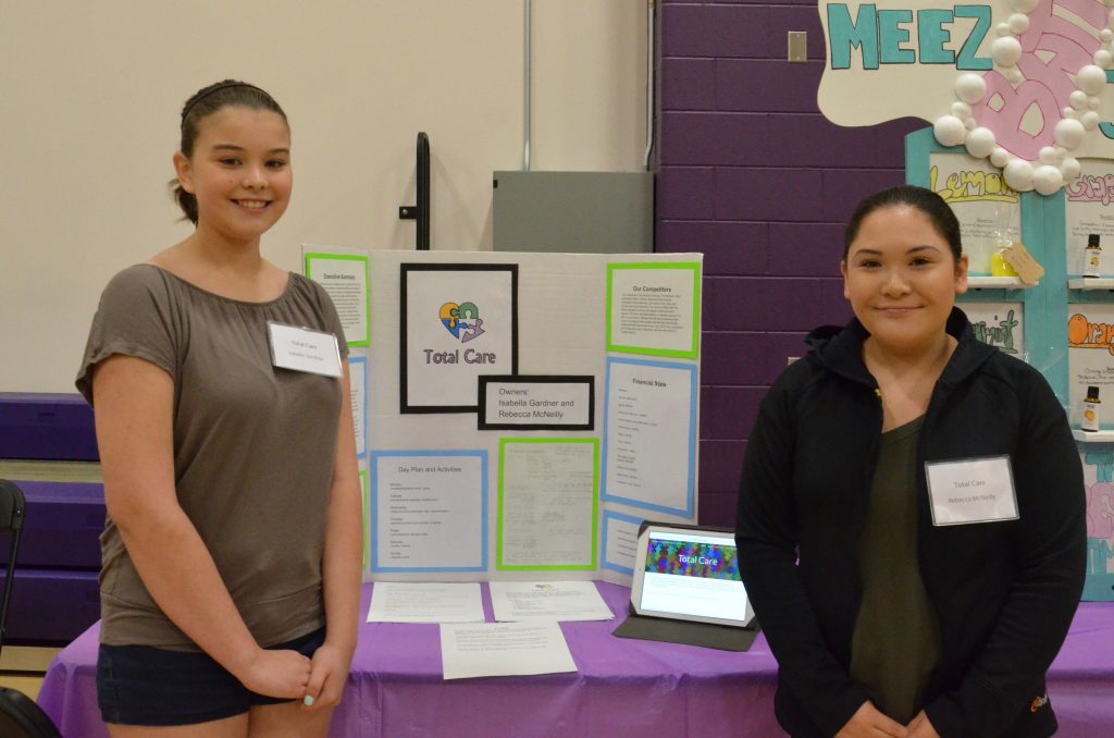 Image of a student with their entrepreneurship fair project