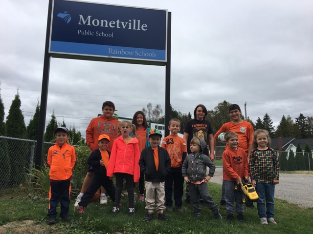 Students at Monetville wear orange shirts