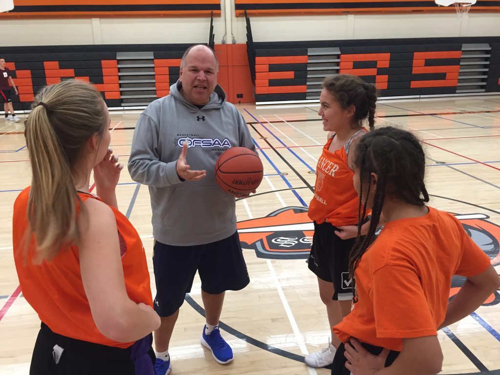 An image of Coach Gauthier and Girls' basketball team at Lasalle