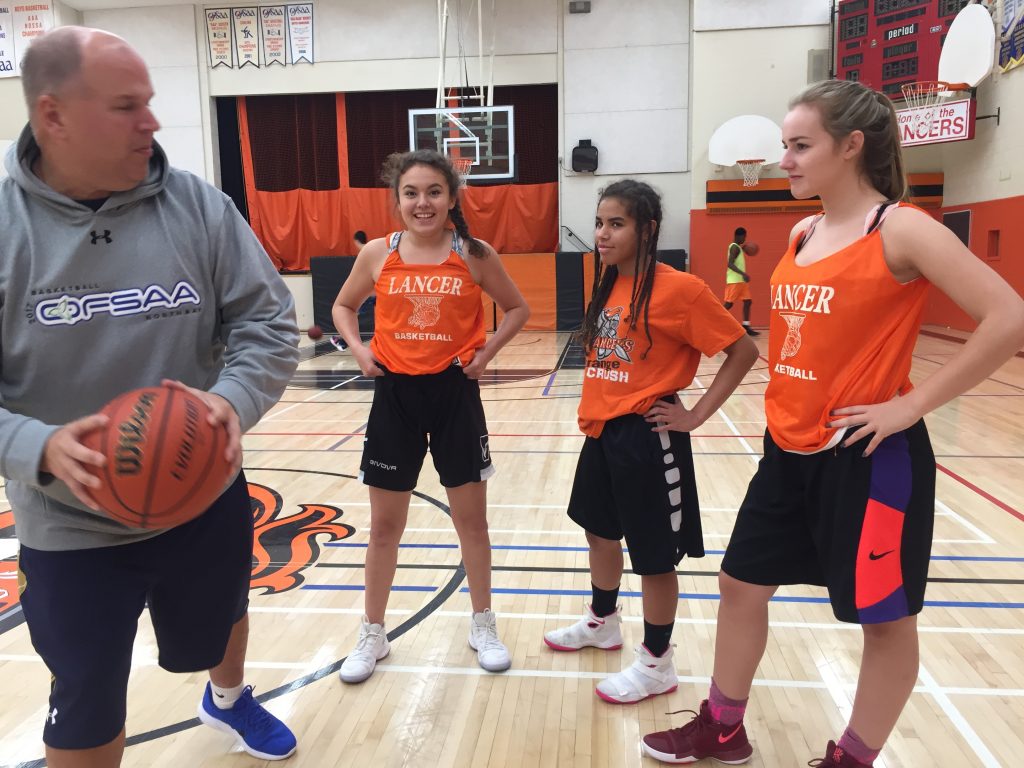 An image of Coach Gauthier and Girls' basketball team at Lasalle