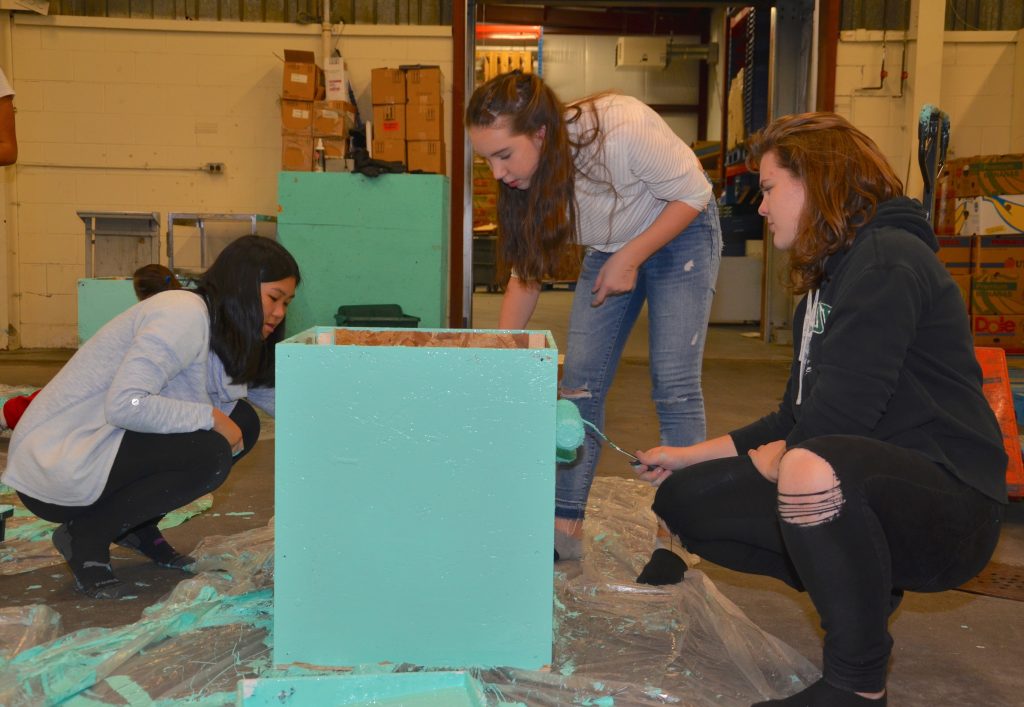 MacLeod students painting donation boxes