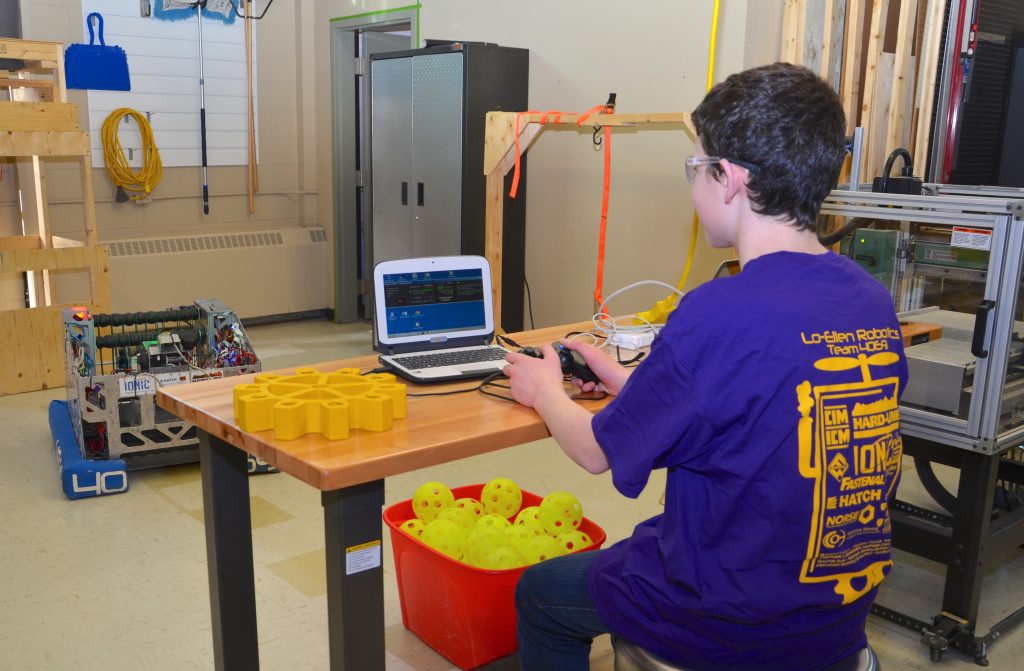 A student working on the FIRST Robotics