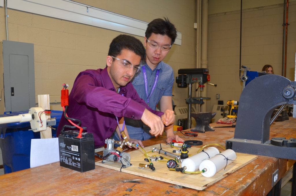 Two students working on pneumatics