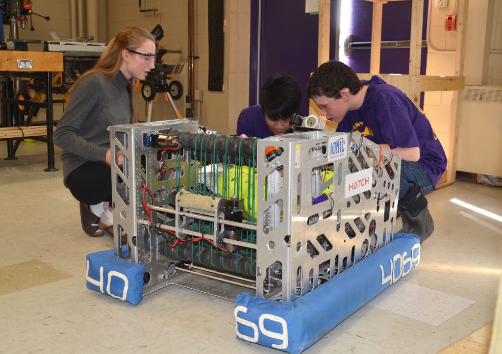 Three students working on the Lo-Ellen Park Robot