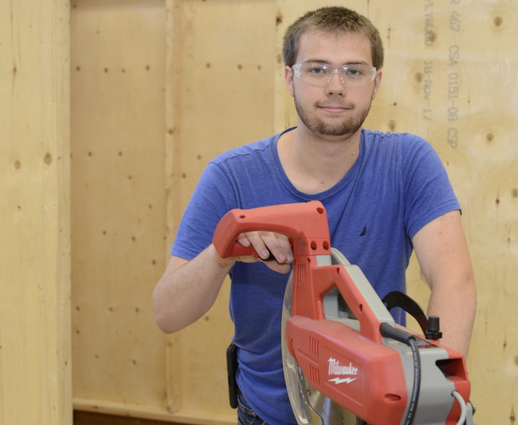 A student holding a tool