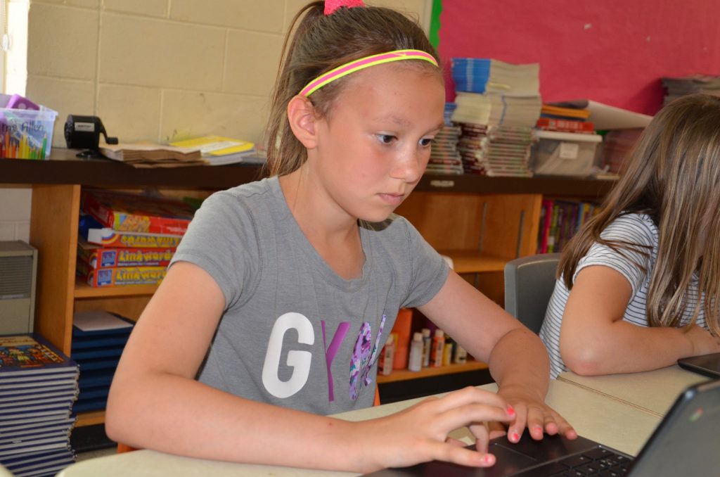 Maeve Leduc, a Grade 5 student from R.L. Beattie Public School, uses a Chromebook.