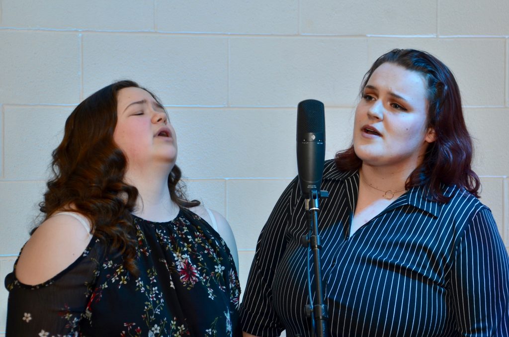 two students singing