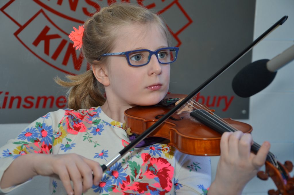 a photo of a student playing the violin