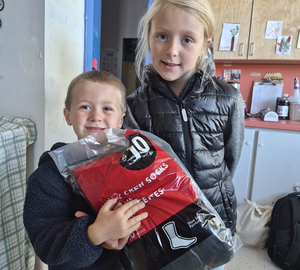 R.L. Beattie Public School students James Demianiuk, left, and Grace Demianiuk proudly showcase items they donated for the 'Thankful for Comfort' bundles for the Elgin Street Mission.