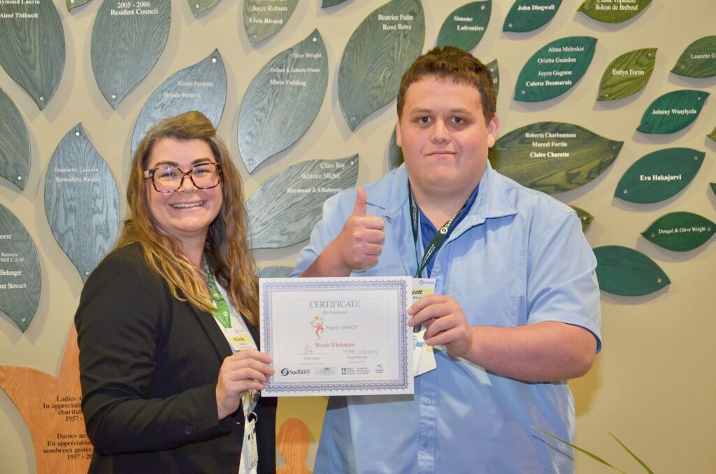 Project SEARCH Pioneer Manor participant Wyatt Whitmore of Chelmsford Valley District Composite School receives a Certificate of Internship from Nicole Leclair, Director of Long-Term Care Services with the City of Greater Sudbury.