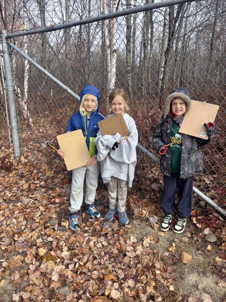 C.R. Judd Public School Grade 1 students River Rifou, left, Eleanor Edmonds and Jasper Durocher observe and document natural objects outdoors for Take Me Outside Day.
