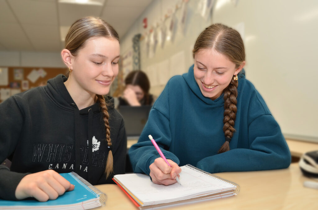 Lo-Ellen Park Secondary School students, Ewa Breckon, left, and Kensington Welsh, work collaboratively on a writing assignment in class.